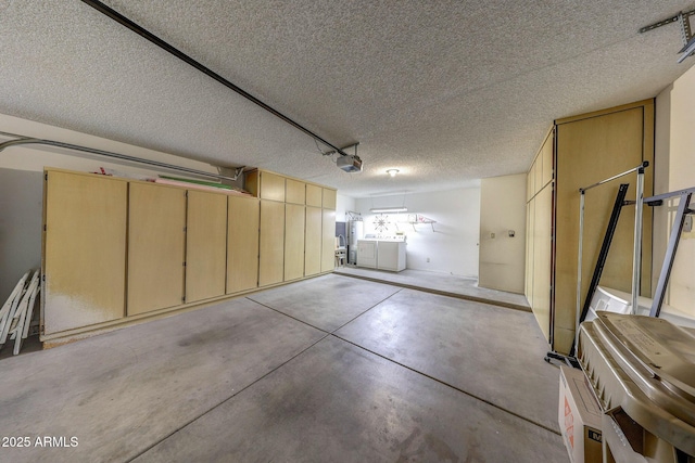 garage featuring washer and clothes dryer and a garage door opener