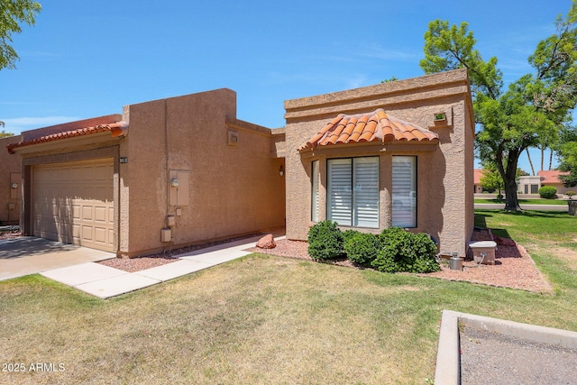 view of front of home with a tile roof, a garage, stucco siding, a front yard, and driveway