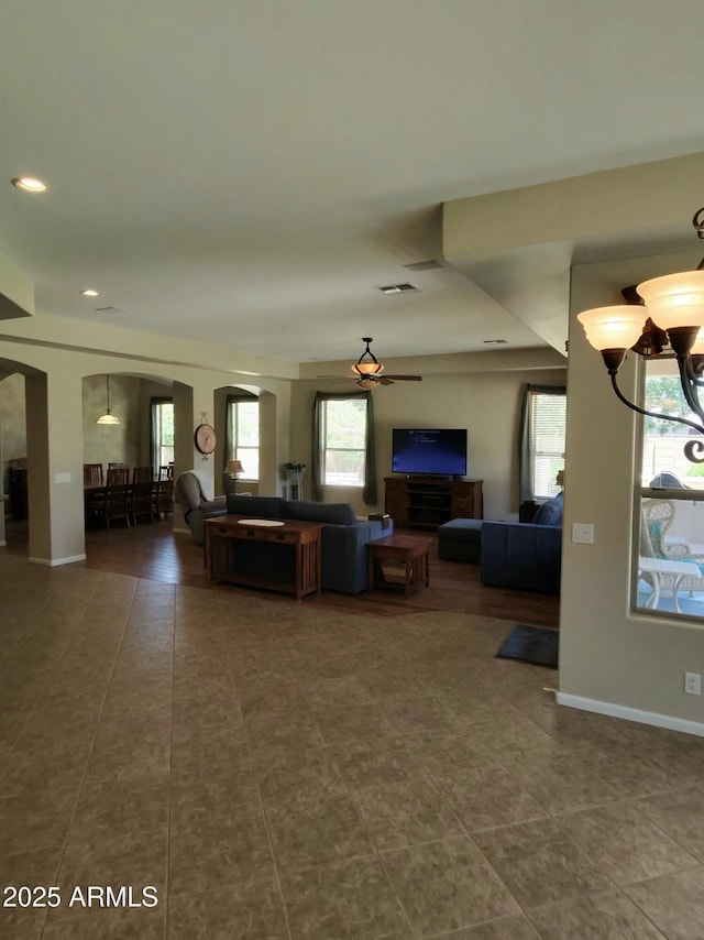 3225 E Cardinal Ct, Chandler, AZ 85286 - living room featuring arched walkways, tile patterned floors, a chandelier, recessed lighting, and a ceiling fan