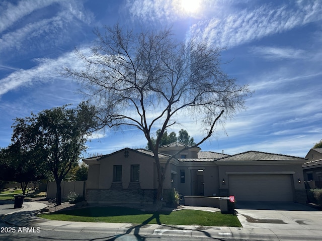 3225 E Cardinal Ct, Chandler, AZ 85286 - view of front facade with stucco siding, stone siding, an attached garage, and concrete driveway