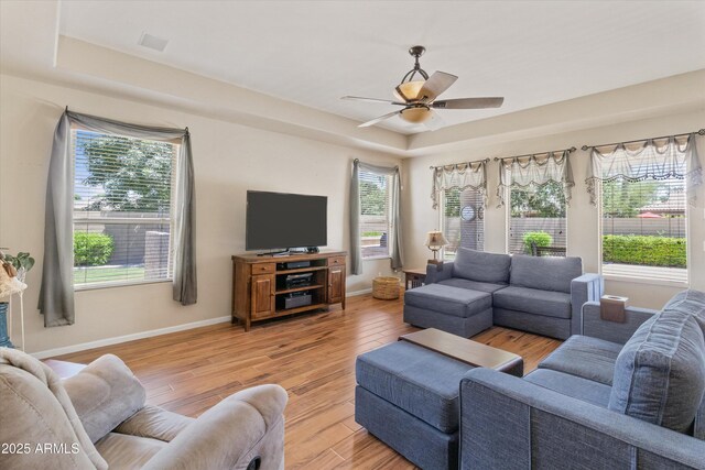 3225 E Cardinal Ct, Chandler, AZ 85286 - living room featuring light wood finished floors, ceiling fan, and a tray ceiling