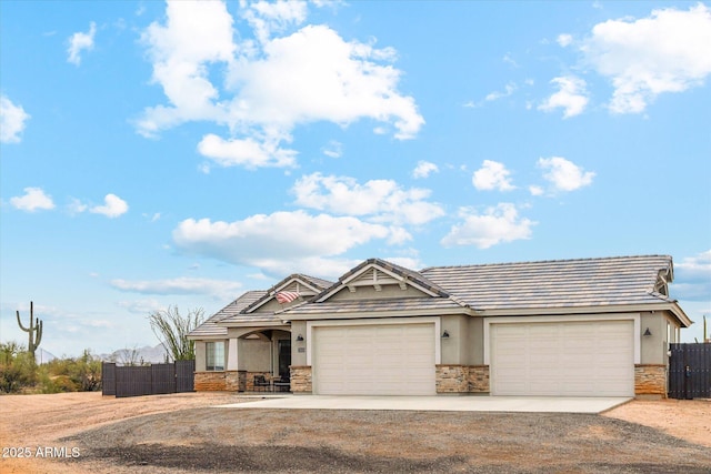 27420 N 170th St, Rio Verde, AZ 85263 - view of front of property featuring concrete driveway, fence, stone siding, and a garage
