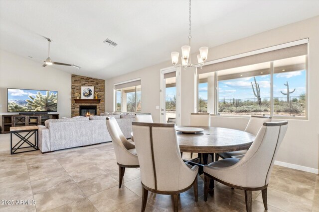 27420 N 170th St, Rio Verde, AZ 85263 - dining space featuring a fireplace, visible vents, vaulted ceiling, and a healthy amount of sunlight