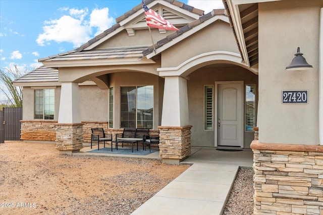 27420 N 170th St, Rio Verde, AZ 85263 - doorway to property featuring a tiled roof, a porch, stone siding, and stucco siding