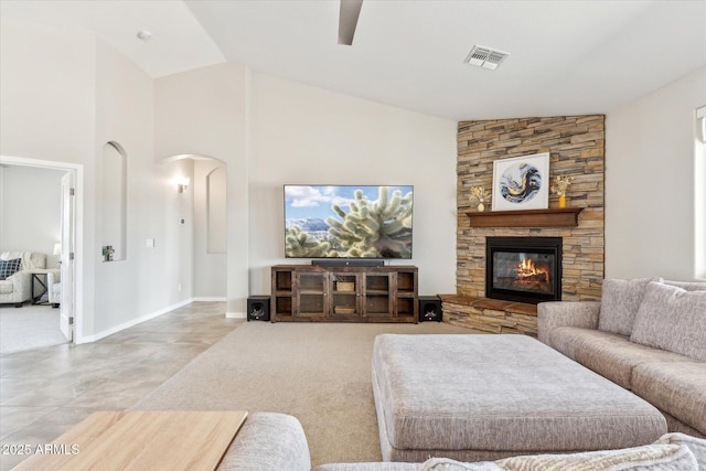 27420 N 170th St, Rio Verde, AZ 85263 - carpeted living room with arched walkways, a ceiling fan, a stone fireplace, visible vents, and lofted ceiling