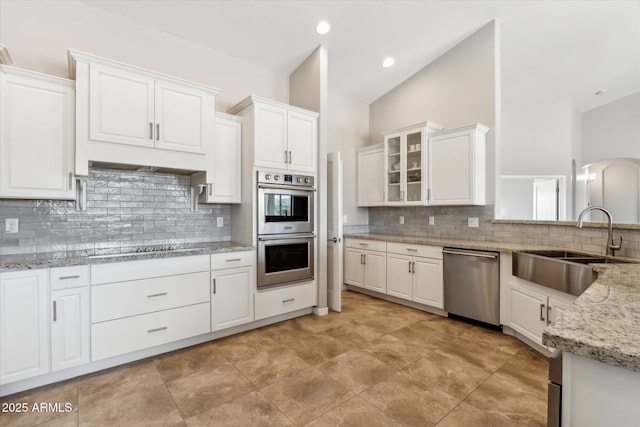 27420 N 170th St, Rio Verde, AZ 85263 - kitchen with a sink, white cabinetry, lofted ceiling, and stainless steel appliances