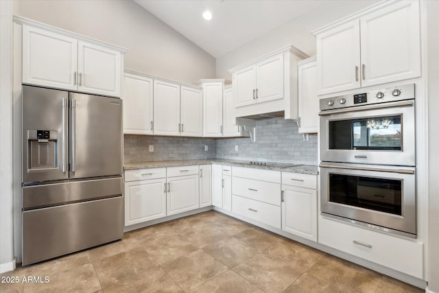 27420 N 170th St, Rio Verde, AZ 85263 - kitchen featuring white cabinetry, backsplash, appliances with stainless steel finishes, and vaulted ceiling
