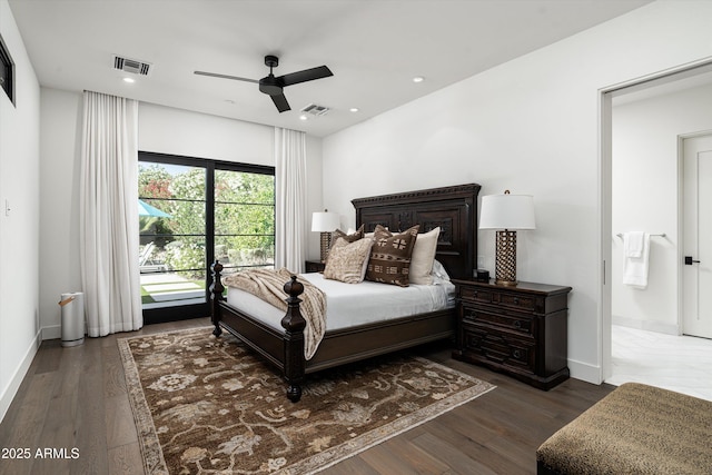 bedroom with baseboards, wood finished floors, and visible vents