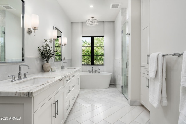 full bathroom featuring visible vents, a sink, and a shower stall