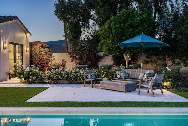 outdoor pool featuring a yard, an outdoor living space, and a patio area