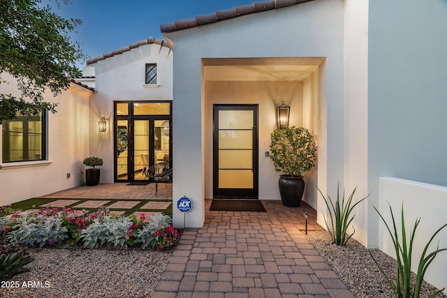 property entrance with stucco siding