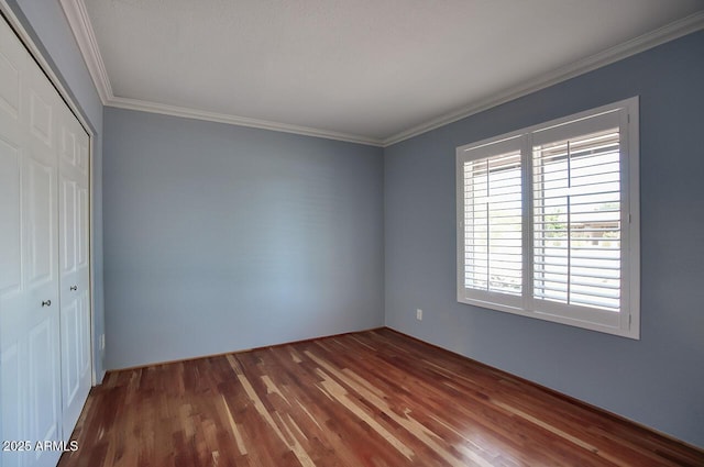 4079 E Shangri La Rd, Phoenix, AZ 85028 - unfurnished bedroom with a closet, dark wood-style floors, and crown molding