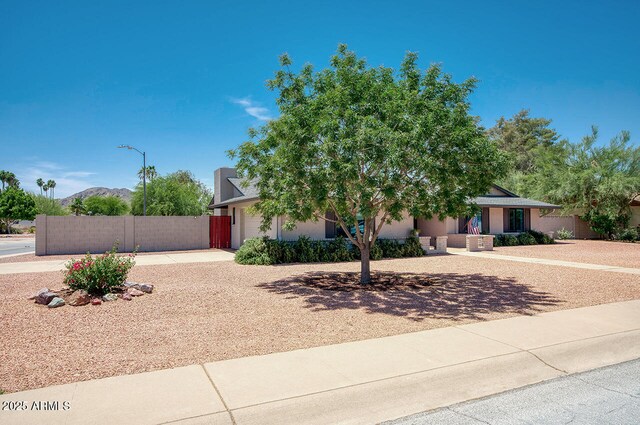 4079 E Shangri La Rd, Phoenix, AZ 85028 - obstructed view of property featuring fence, a garage, concrete driveway, and stucco siding