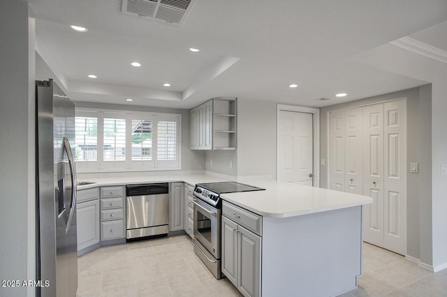 4079 E Shangri La Rd, Phoenix, AZ 85028 - kitchen with appliances with stainless steel finishes, gray cabinets, a peninsula, open shelves, and recessed lighting