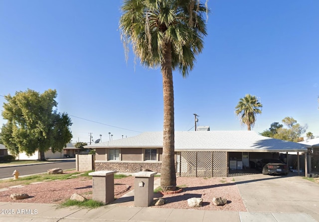 ranch-style home featuring concrete driveway