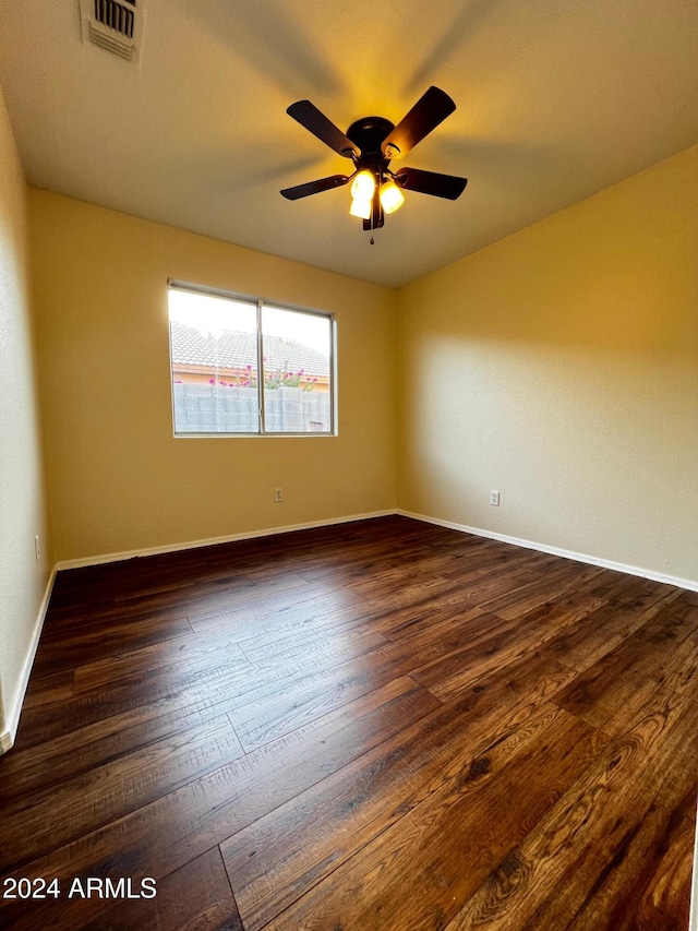 unfurnished room with ceiling fan and dark hardwood / wood-style flooring