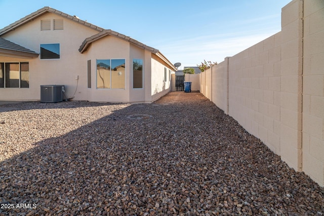 rear view of house featuring central air condition unit