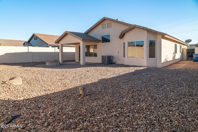 back of house featuring central AC and a patio area