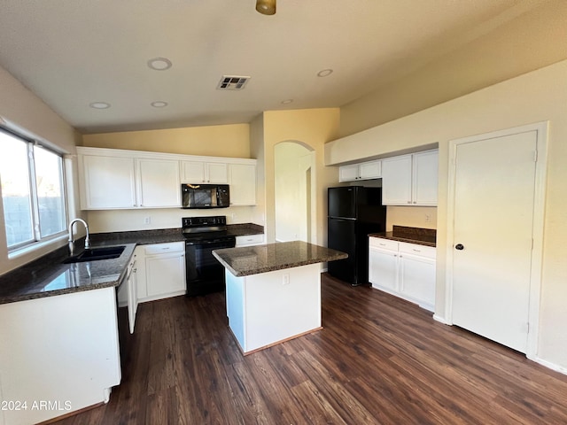 kitchen featuring a kitchen island, white cabinetry, lofted ceiling, sink, and black appliances