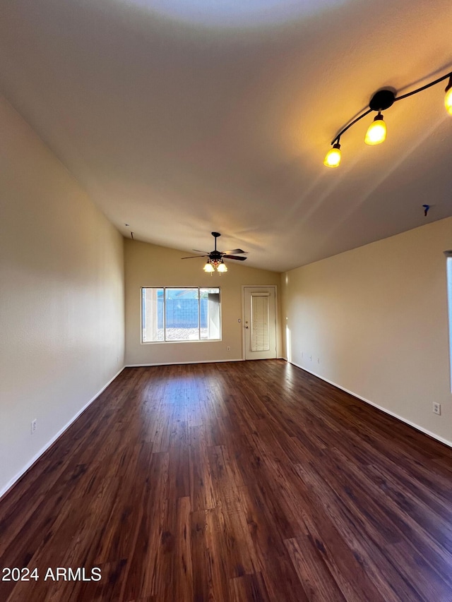 unfurnished living room with dark wood-type flooring and ceiling fan