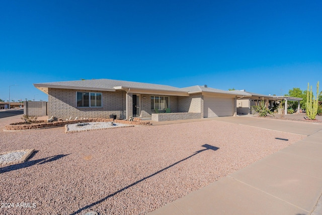 view of front facade with a garage, concrete driveway, and brick siding