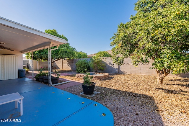 view of yard featuring a patio, a fenced backyard, and a ceiling fan