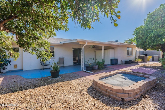 rear view of property with a ceiling fan, a patio, fence, central AC, and brick siding