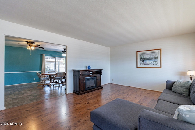 living area featuring a glass covered fireplace and wood finished floors