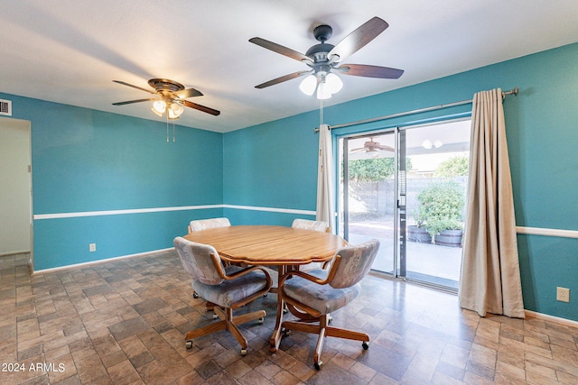 dining area with stone finish flooring, visible vents, and baseboards