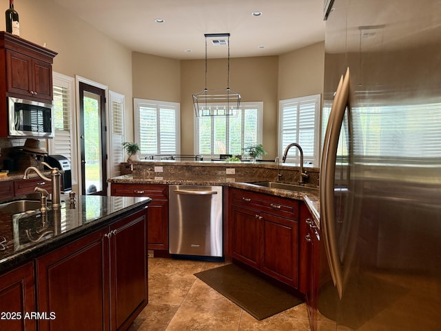 12036 E Via De Palmas, Chandler, AZ 85249 - kitchen with stainless steel appliances, a sink, plenty of natural light, recessed lighting, and dark brown cabinets
