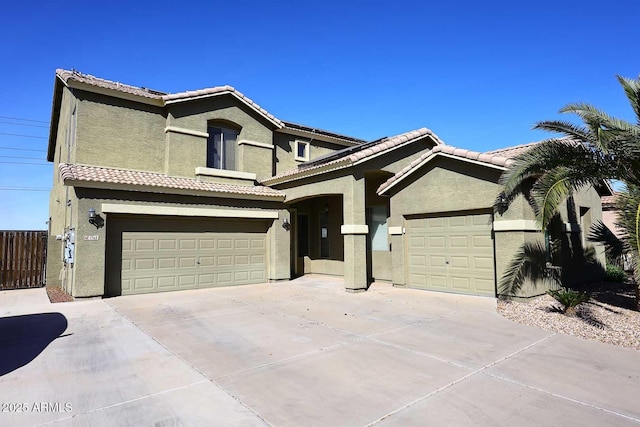 traditional-style home featuring concrete driveway, a tiled roof, and stucco siding