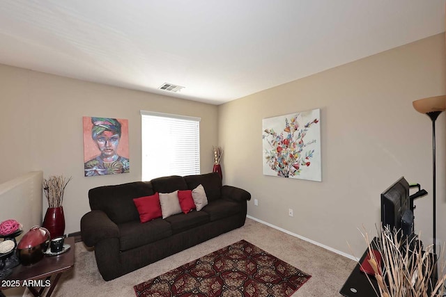 carpeted living area with visible vents and baseboards