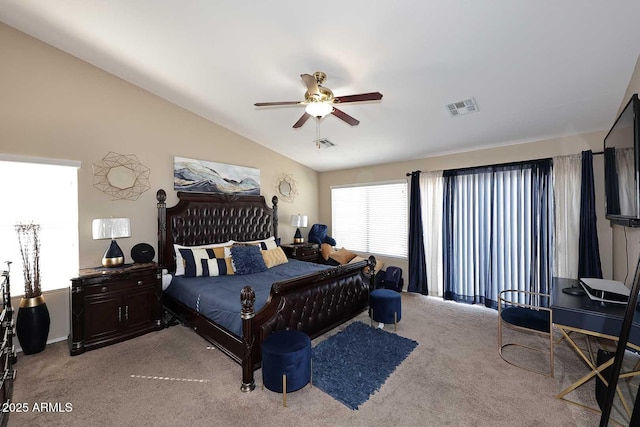 carpeted bedroom with visible vents, vaulted ceiling, and a ceiling fan