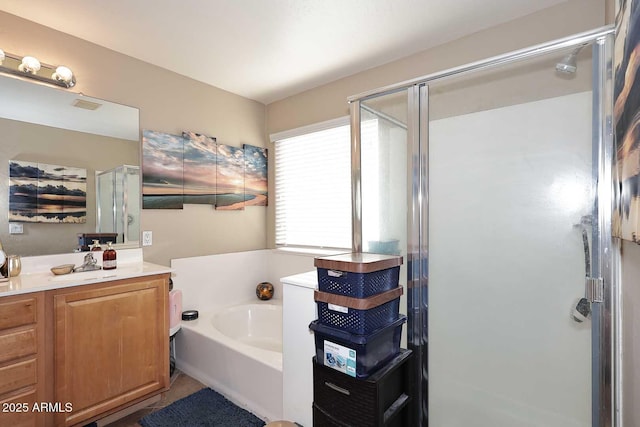 full bathroom featuring a stall shower, vanity, and a bath