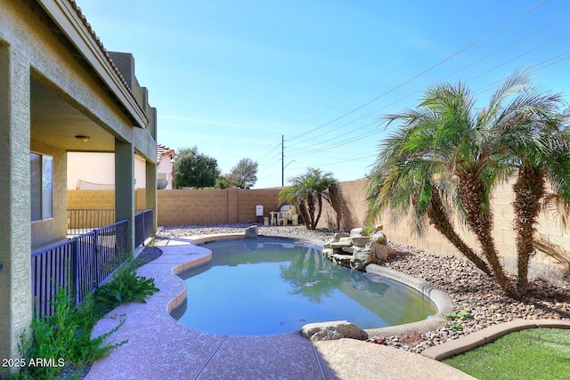 view of swimming pool with a fenced backyard