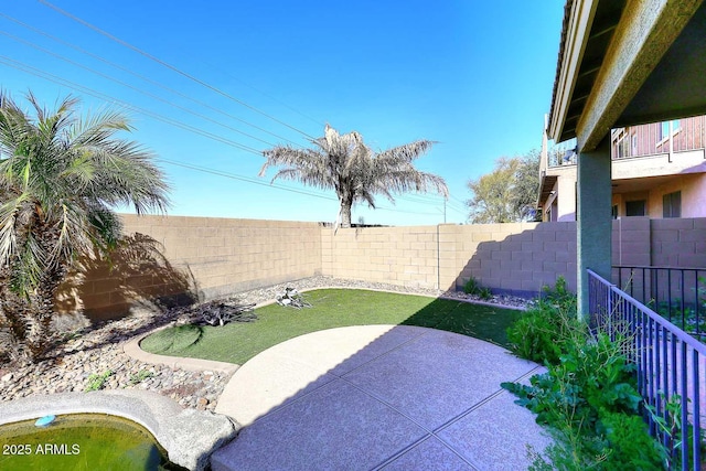 view of yard with a patio area and a fenced backyard