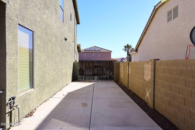 view of patio featuring a gate and fence