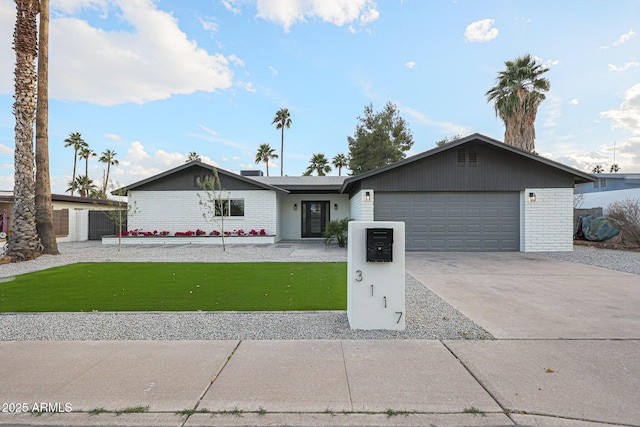 ranch-style home featuring a garage and a front lawn