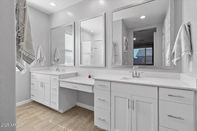 19447 W Mariposa Dr, Litchfield Park, AZ 85340 - full bathroom with a stall shower, wood finished floors, two vanities, and recessed lighting
