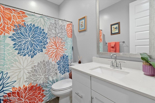 19447 W Mariposa Dr, Litchfield Park, AZ 85340 - bathroom with toilet, vanity, a textured wall, and a shower with shower curtain