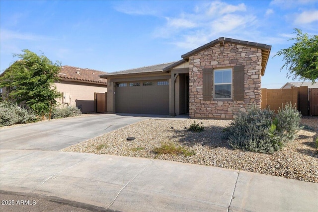 19447 W Mariposa Dr, Litchfield Park, AZ 85340 - view of front facade with stone siding, driveway, a garage, stucco siding, and fence