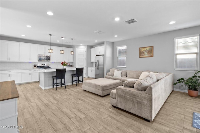 19447 W Mariposa Dr, Litchfield Park, AZ 85340 - living area with recessed lighting, plenty of natural light, light wood-style flooring, and baseboards