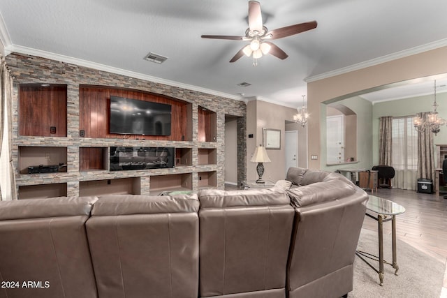 living room with ceiling fan with notable chandelier, light wood-type flooring, and crown molding