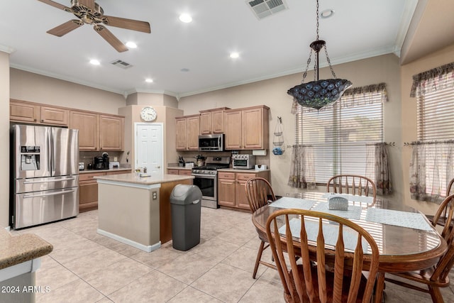 kitchen featuring a wealth of natural light, a kitchen island, crown molding, and appliances with stainless steel finishes