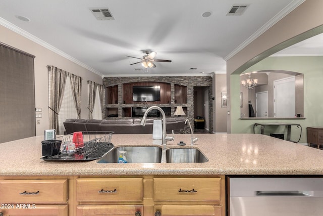 kitchen with light brown cabinetry, sink, ceiling fan with notable chandelier, and ornamental molding