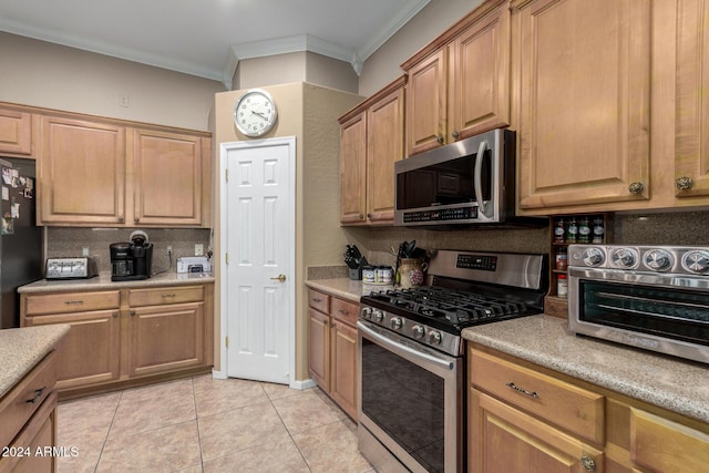 kitchen with backsplash, stainless steel appliances, crown molding, and light tile patterned flooring