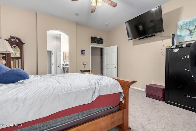 bedroom featuring ensuite bath, ceiling fan, and carpet floors