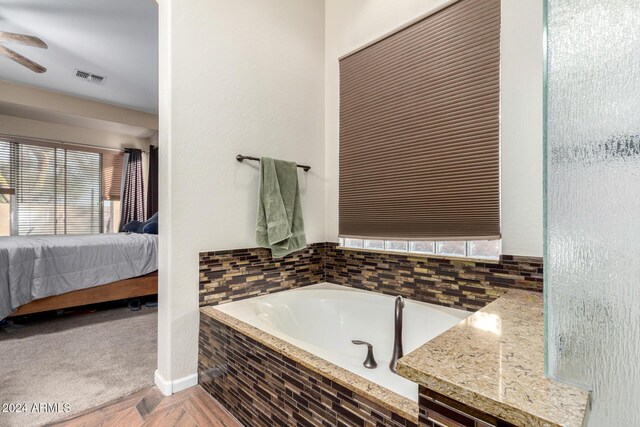 bathroom with tiled tub