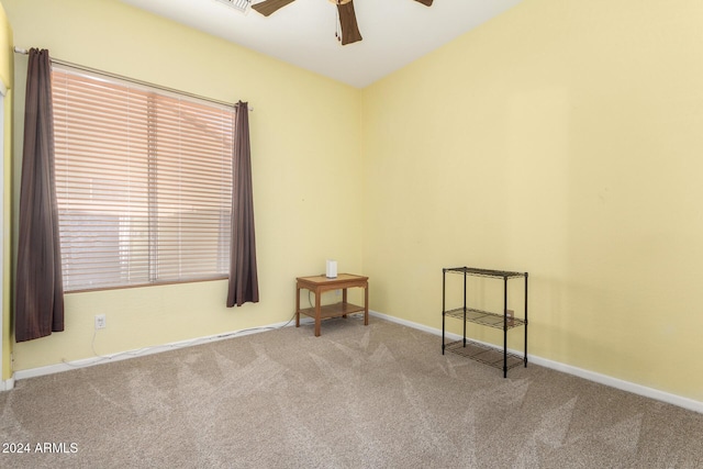 empty room with light colored carpet and ceiling fan