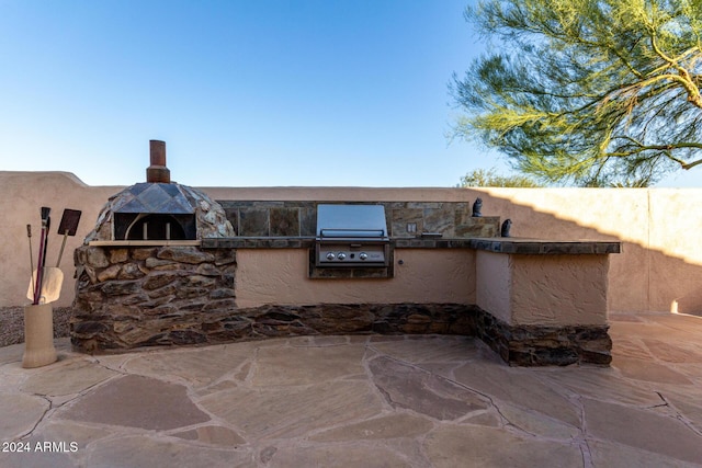 view of patio / terrace featuring area for grilling and a grill